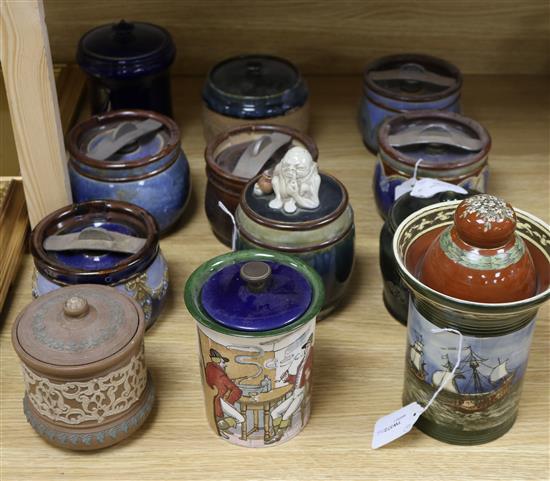 Twelve Doulton tobacco jars and covers, various designs including a figural example